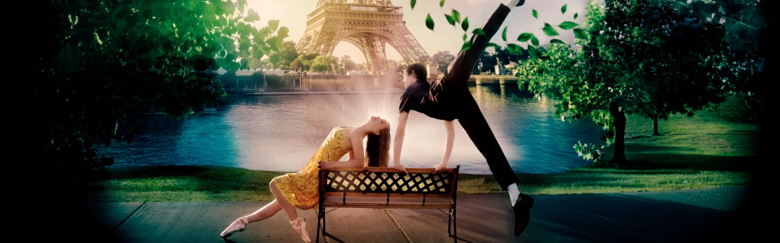 A woman and man dancing on a bench in front of the Eiffel Tower