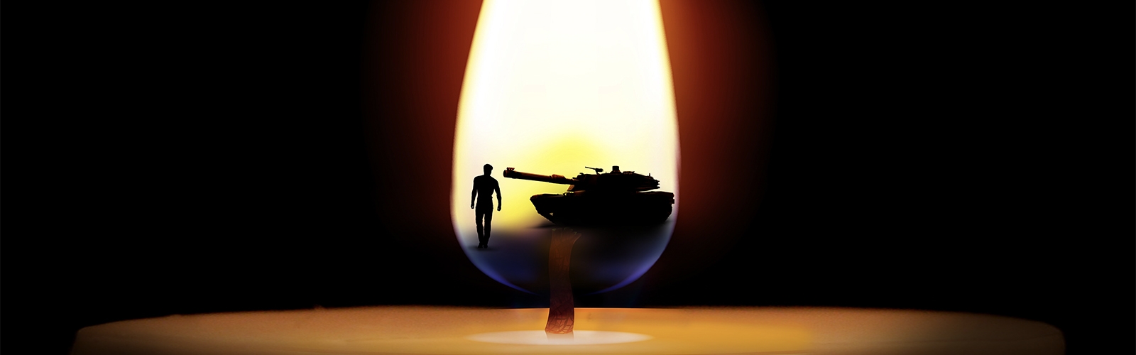 A burning candle reflects a man standing in front of a tank in the flame.