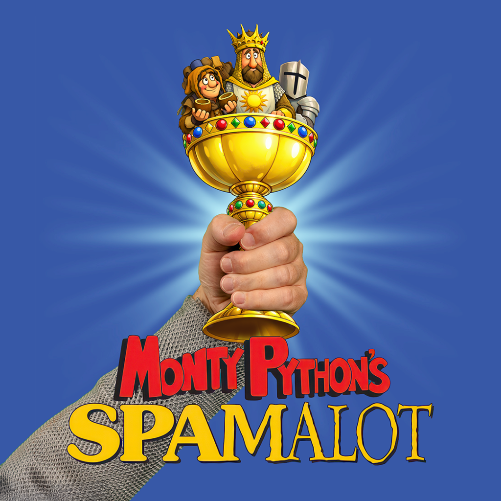 Promotional artwork for “Monty Python’s Spamalot” at The Phoenix Theatre Company, running February 17–May 16, 2027. A realistic hand wearing chainmail holds a cartoon goblet containing a cartoon king, a squire holding coconuts, and a knight. The title appears below.